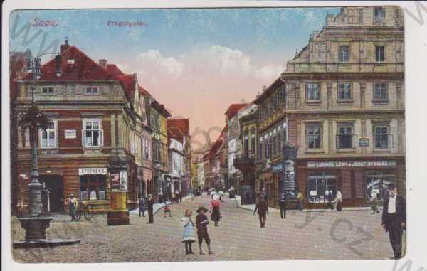  - Žatec (Saaz) - Pražská ulice, lékárna, obchody, kolorovaná